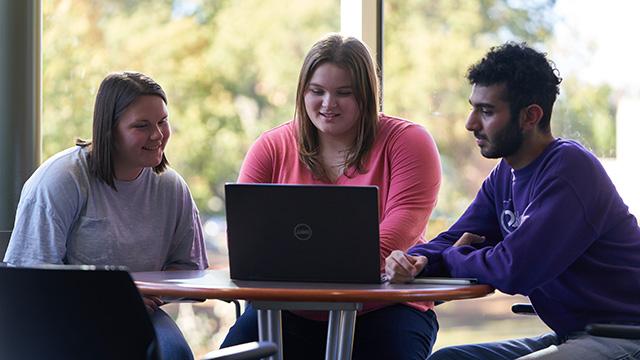 Students gathered around laptop